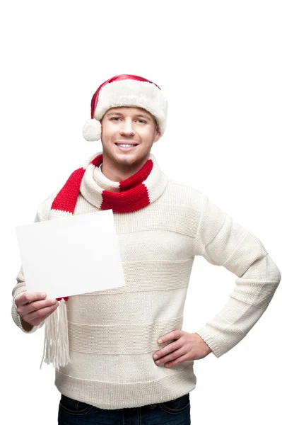 Young casual man in santa hat hoding christmas gift — Stock Photo, Image