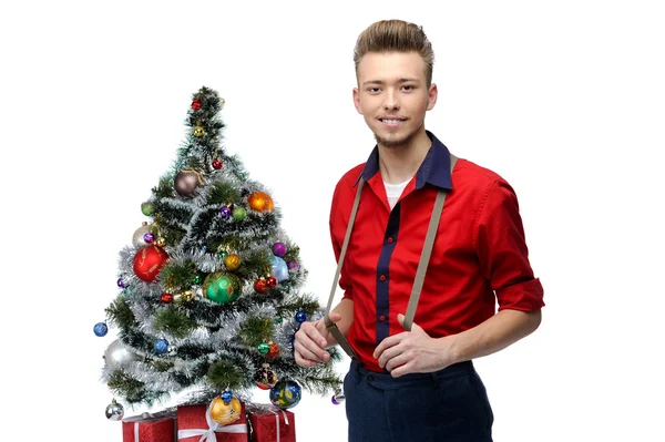 Young vintage man standing near christmas tree — Stock Photo, Image