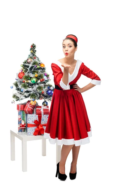 Cheerful retro girl standing near christmas tree — Stock Photo, Image