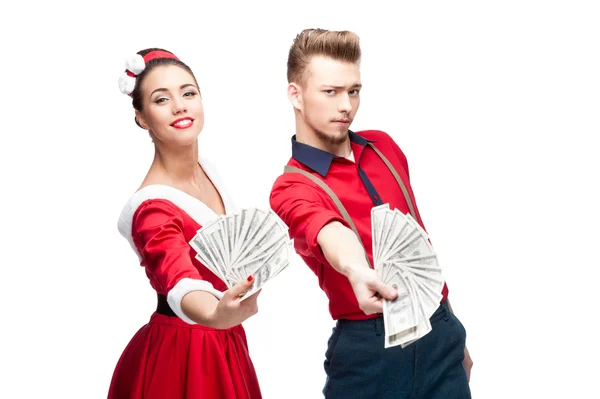 Young retro couple holding money — Stock Photo, Image