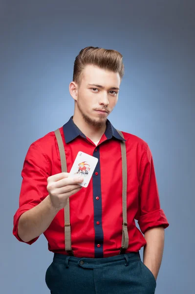 Retro man holding Jocker card — Stok fotoğraf