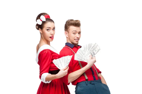 Young retro couple holding money — Stock Photo, Image