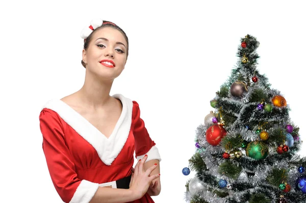 Cheerful retro girl standing near christmas tree — Stock Photo, Image