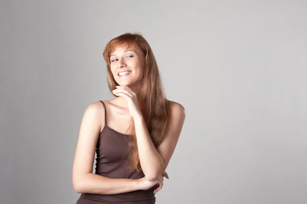 Cheerful casual girl on gray — Stock Photo, Image