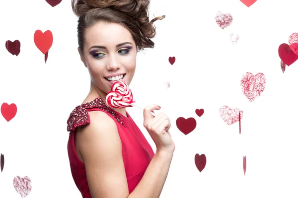 Brunette woman holding lollipop — Stock Photo, Image