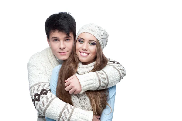 Young smiling couple in winter clothing embracing Stock Picture