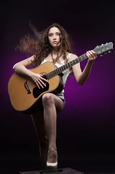 Sexy girl holding guitar — Stock Photo, Image