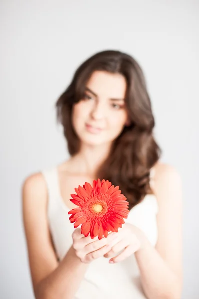 Beautiful girl with red flower — Stock Photo, Image