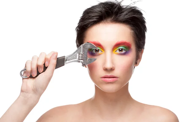 Schöne Frau mit Fantasie-Make-up hält Schraubenschlüssel — Stockfoto
