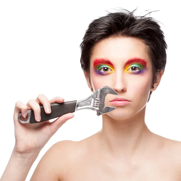 Beautiful woman with fantasy makeup holding wrench — Stock Photo, Image