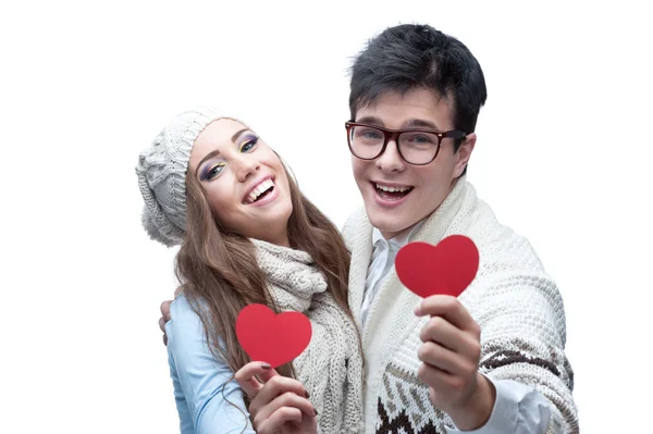 Young cheerful casual couple holding red hearts — Stock Photo, Image