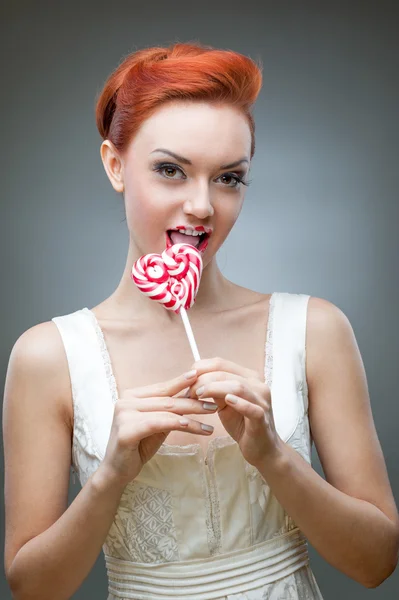 Red woman holding lollipop — Stock Photo, Image