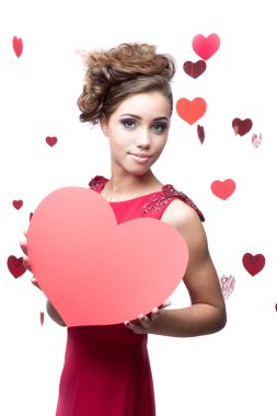 Kırmızı kağıt kalp tutan neşeli genç kadın