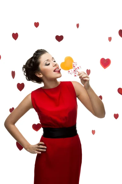 Brunette woman holding lollipop — Stock Photo, Image