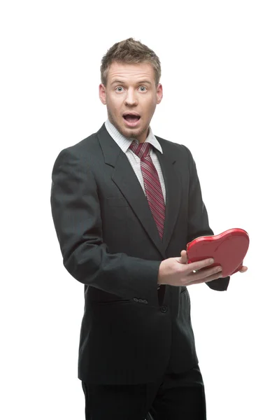 Cheerful businessman holding red heart — Stock Photo, Image