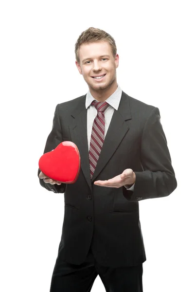 Cheerful businessman holding red heart — Stock Photo, Image