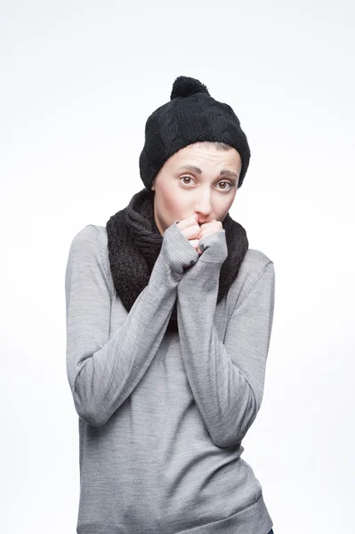 Young freezing girl on gray background — Stock Photo, Image