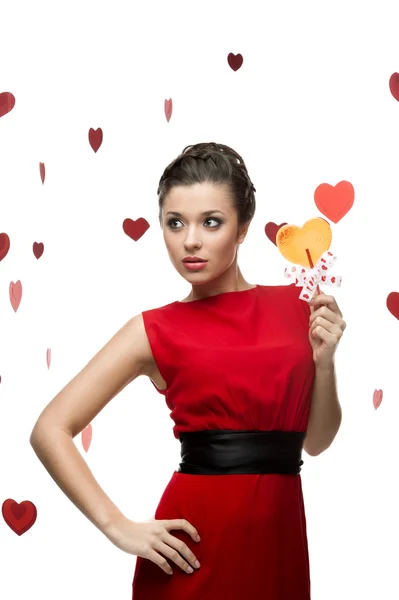 Caucasian woman in red dress holding lollipop — Stock Photo, Image