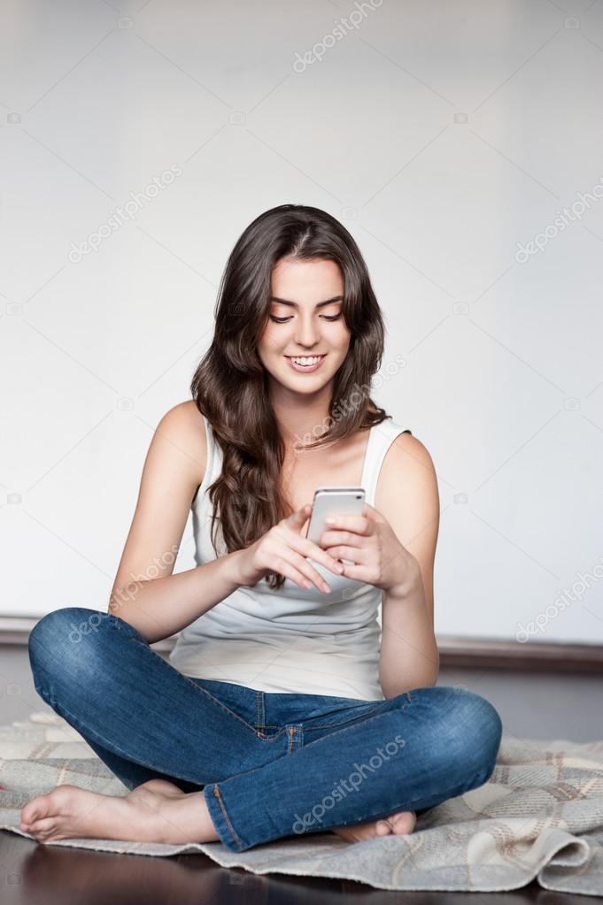 casual brunette girl holding cell phone