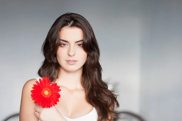 Beautiful girl with red flower — Stock Photo, Image