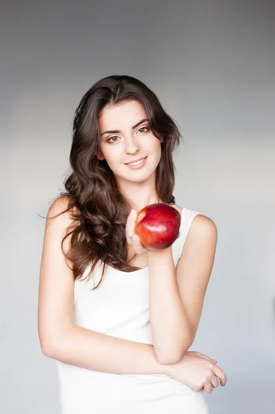Cheerful girl holding apple — Stock Photo, Image