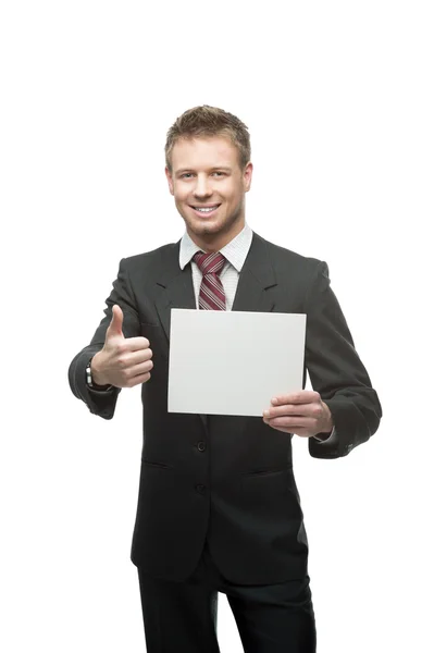 Joven hombre de negocios sonriente sosteniendo cartel — Foto de Stock