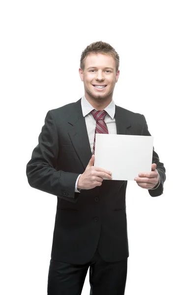 Joven hombre de negocios sonriente sosteniendo cartel — Foto de Stock