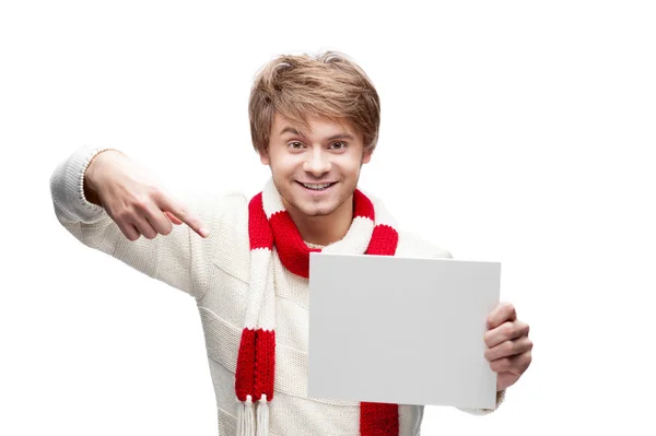 Young funny man pointing at sign — Stock Photo, Image