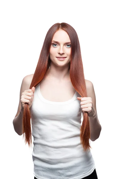 Beautiful red haired girl holding her hair — Stock Photo, Image