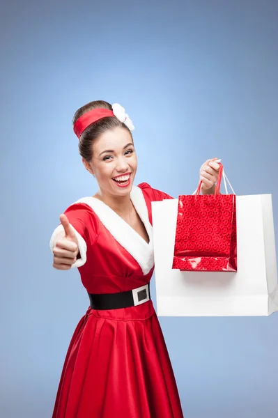 Cheerful retro girl holding shopping bags — Stock Photo, Image