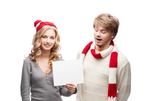 Young happy christmas couple holding sign — Stock Photo, Image