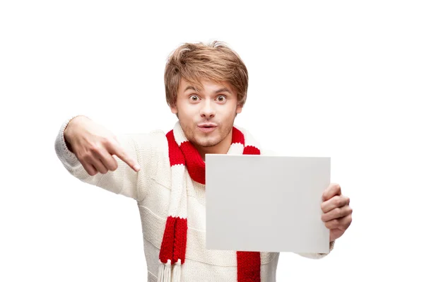 Young funny man pointing at sign — Stock Photo, Image