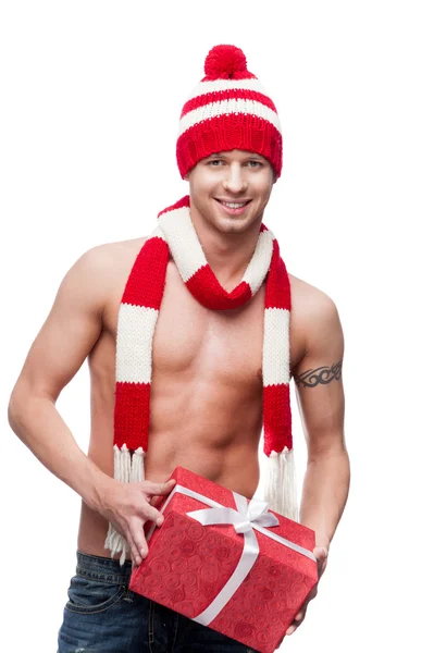 Sexy macho holding red gift — Stock Photo, Image