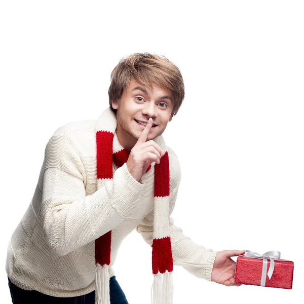 Young smiling man holding gift — Stock Photo, Image