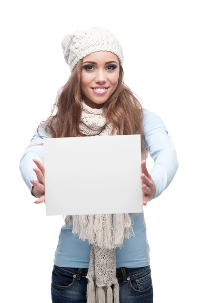 Smiling casual winter girl holding sign — Stock Photo, Image