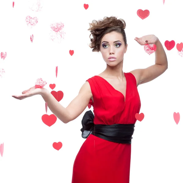 Woman in red dress over red hearts background — Stock Photo, Image