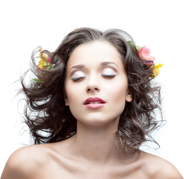 Young woman with flower in hair — Stock Photo, Image