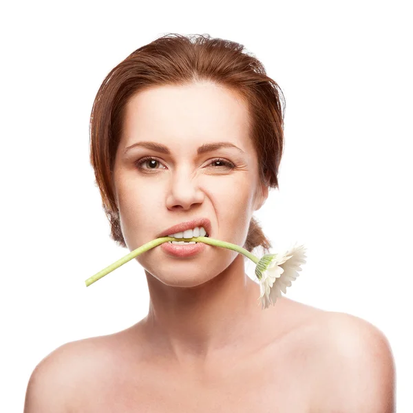 Winking woman with flower in mouth — Stock Photo, Image