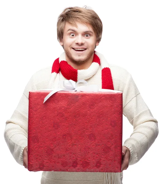 Young funny man holding christmas gift — Stock Photo, Image