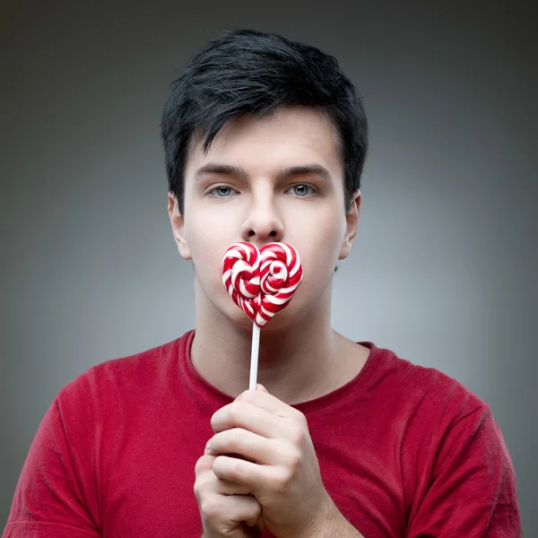 Casual man holding lollipop — Stock Photo, Image