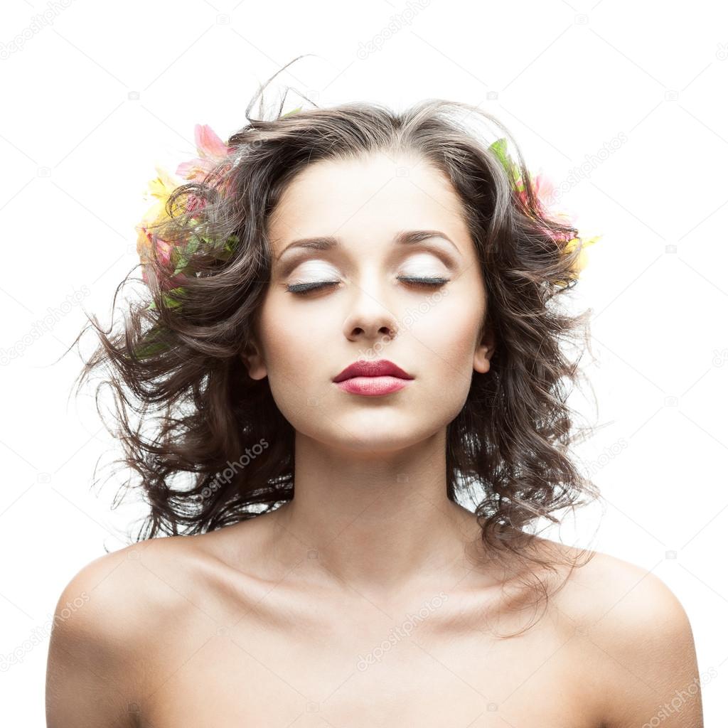 beautiful young woman with flower in blowing hair