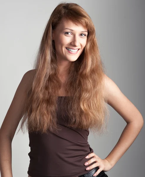 Cheerful casual girl on gray — Stock Photo, Image