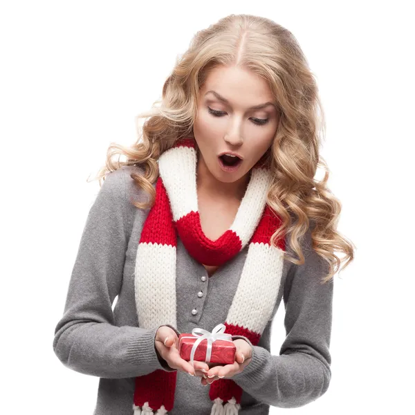 Young surprised woman holding christmas gift — Stock Photo, Image