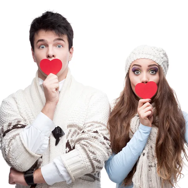 Young cheerful casual couple holding red hearts — Stock Photo, Image