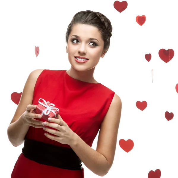 Caucasian woman in red dress holding gift — Stock Photo, Image