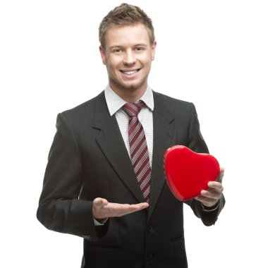 Kırmızı kalp holding neşeli genç işadamı