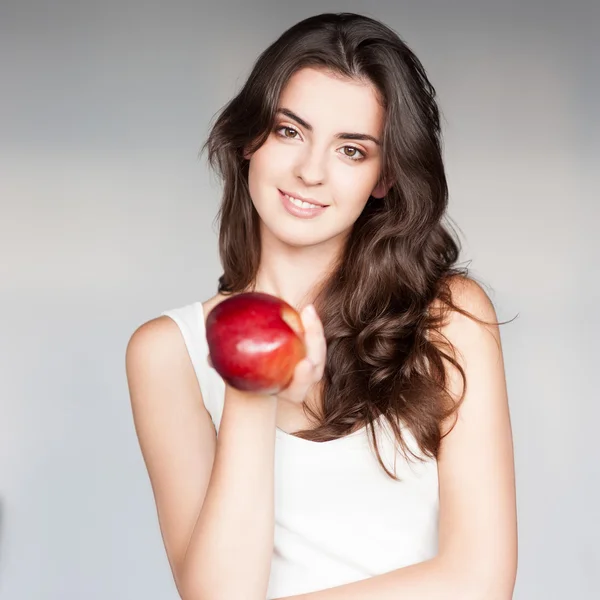 Cheerful girl holding apple — Stock Photo, Image