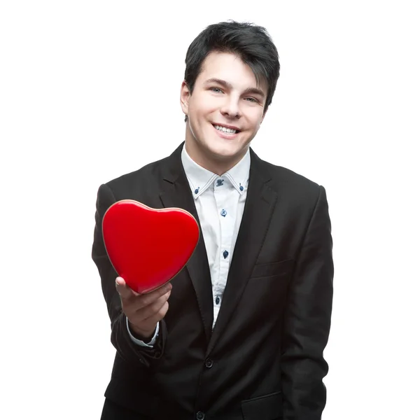 Young businessman holding heart — Stock Photo, Image