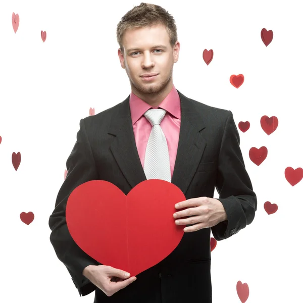 Cheerful businessman holding red heart — Stock Photo, Image