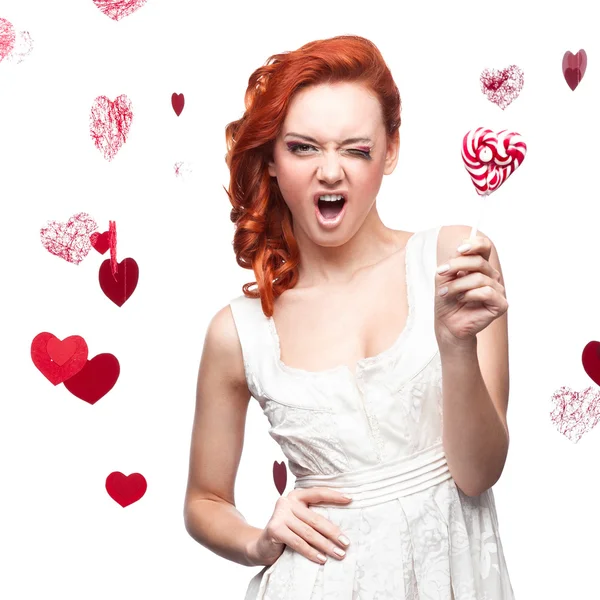 Winking red woman holding lollipop — Stock Photo, Image